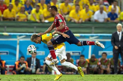Neymar is fouled by Juan Camilo Zuniga of Colombia