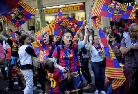 FC Barcelona's supporters wave flags as they celebrate in the streets of Barcelona two days after their team won the Spanish league on May 13, 2013. The Catalans didn't even need to set foot on the pitch to seal the title on May 11 as Real Madrid's 1-1 draw with Espanyol meant Barca had already been crowned champions before their 2-1 win over Atletico Madrid on May 12. AFP PHOTO/ JOSEP LAGO